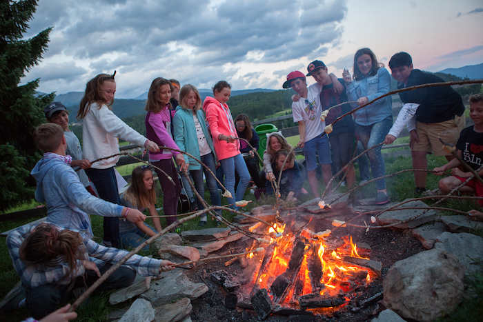 Gemütlicher Abend am Lagerfeuer im Sommercamp Kinder