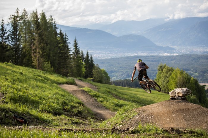 Junge bei einem Jump auf dem Mountainbike im Feriencamp Kärnten