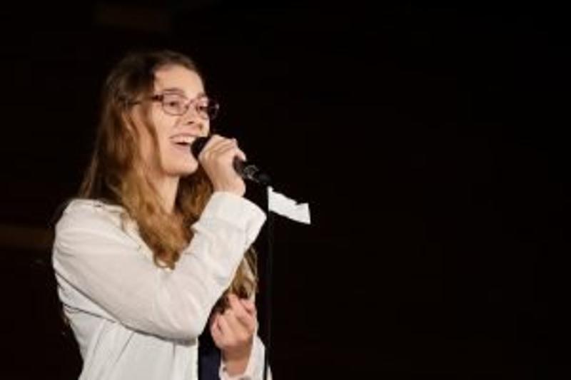 Im Sommercamp singt ein Mädchen auf der Bühne