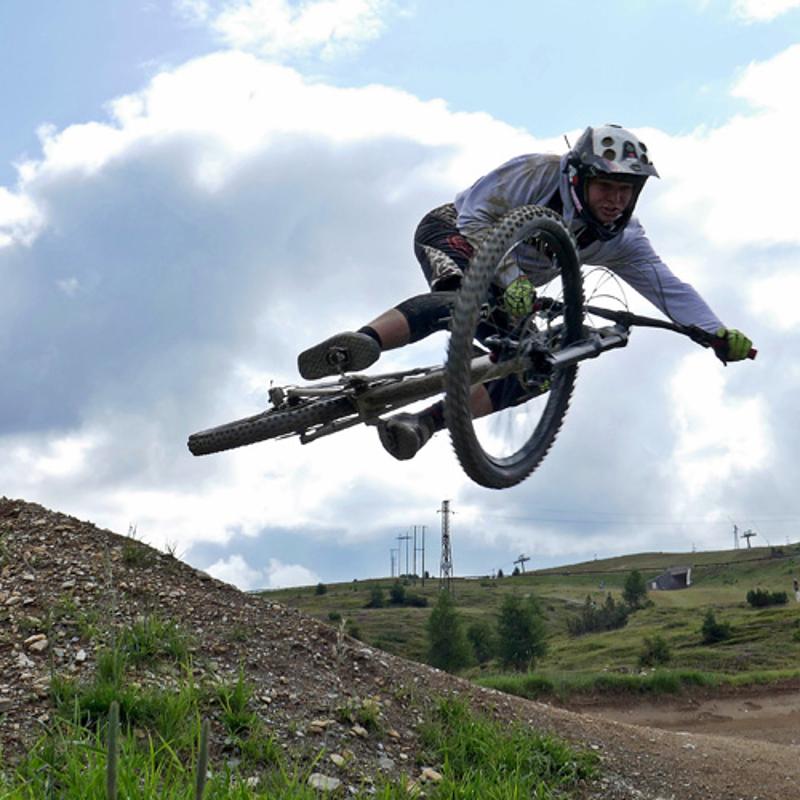 Im MTB-Camp springt ein Junge mit seinem Fahrrad durch die Luft